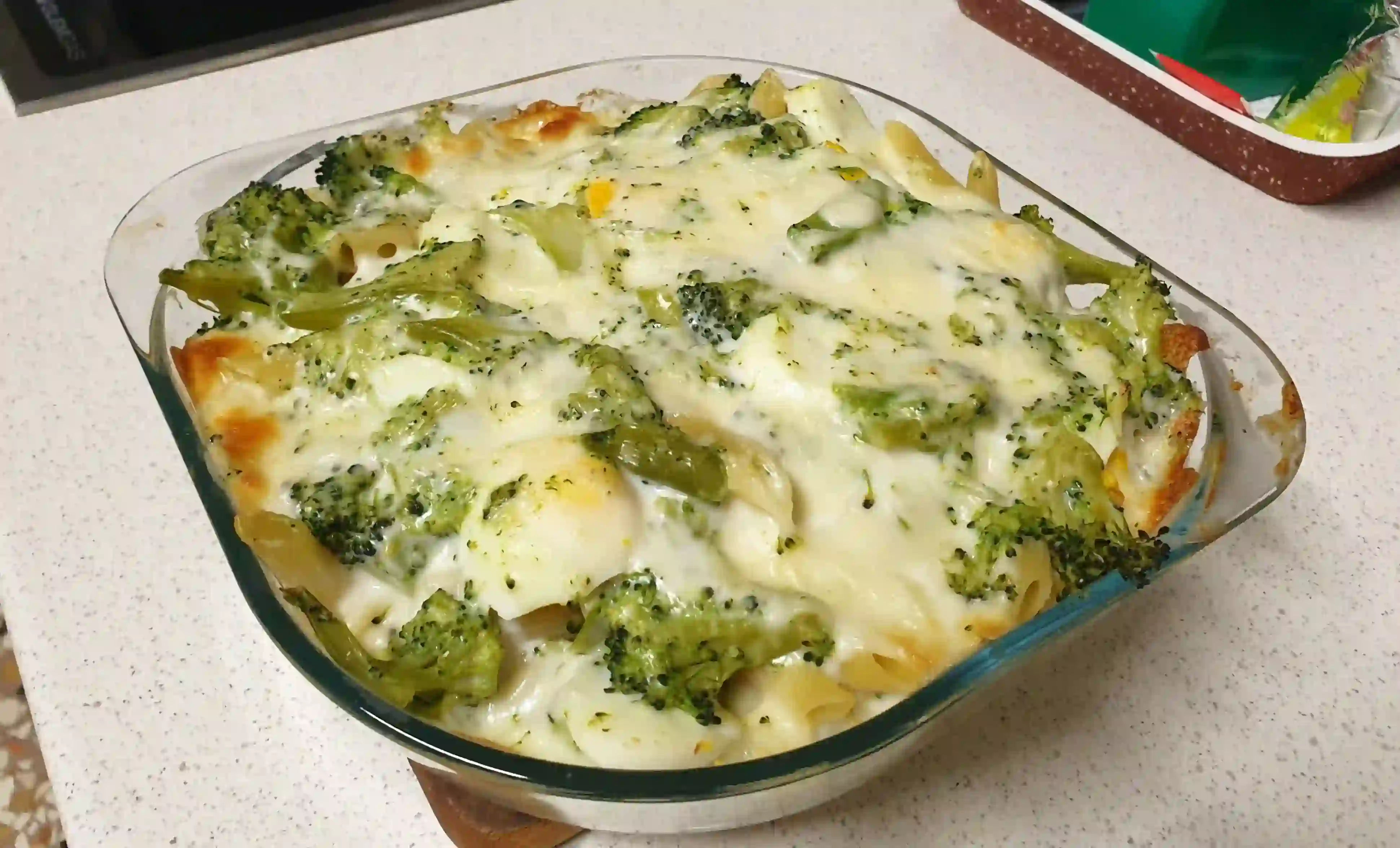 Baked pasta with broccoli, boiled eggs and scamorza cheese